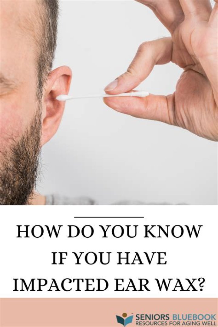 How do doctors get impacted ear wax out?