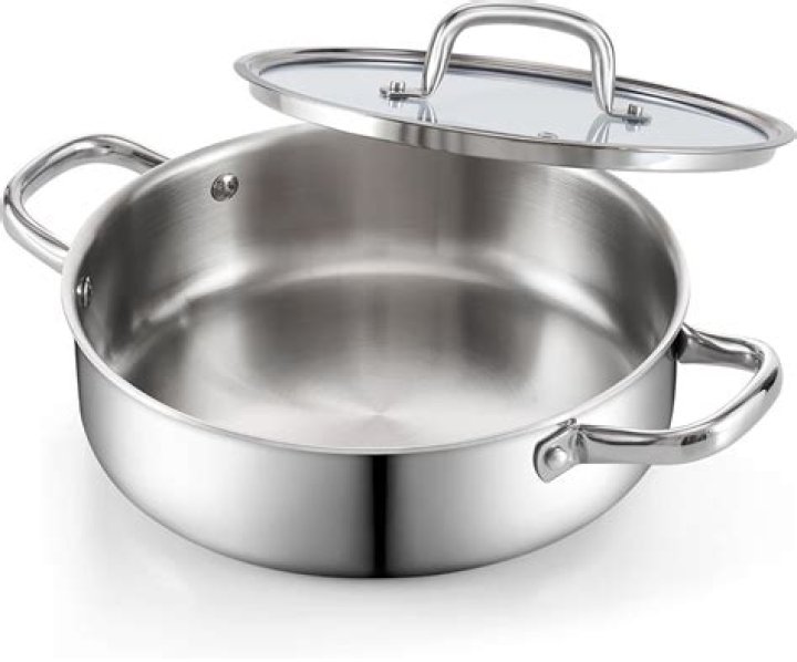 How do you season a stainless steel pan with salt?