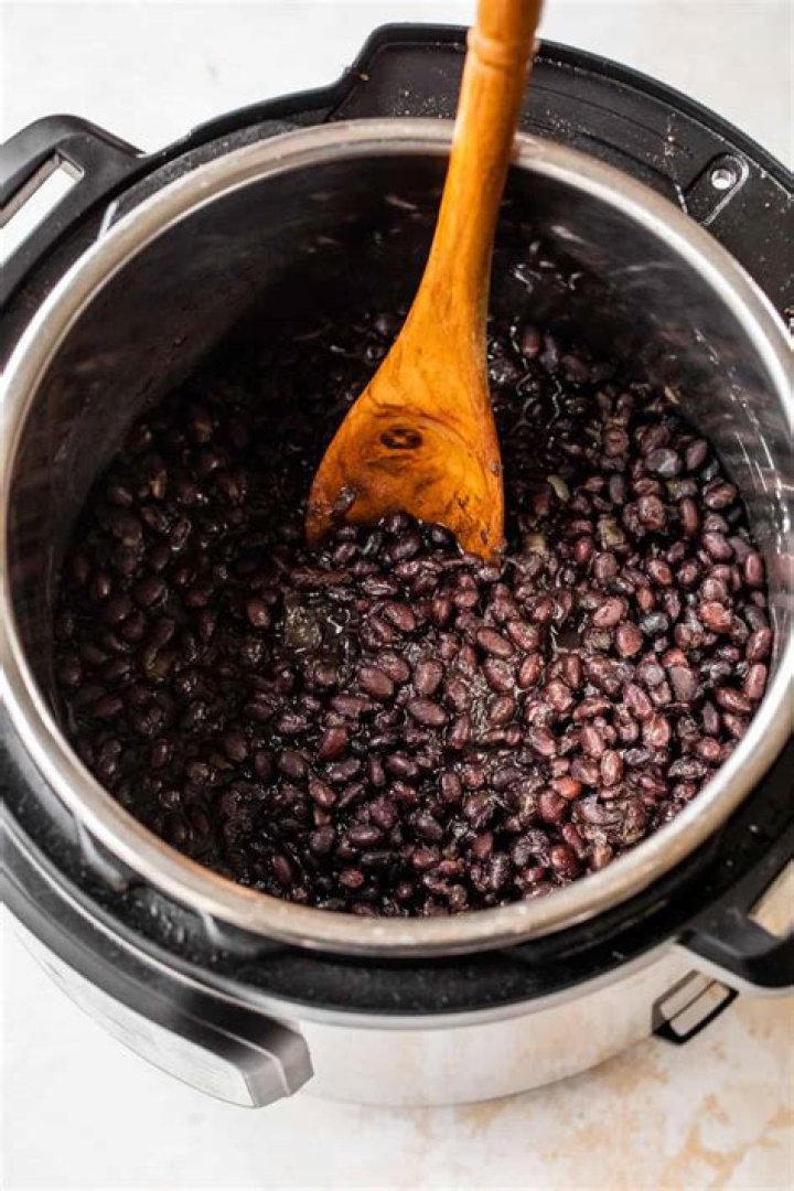 How long does it take to cook raw beans in a pressure cooker?