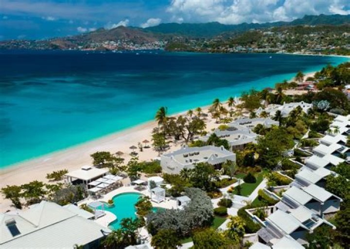 Who owns Spice Island Beach Resort?